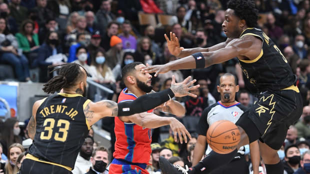 Nov 13, 2021; Toronto, Ontario, CAN; Detroit Pistons guard Cory Joseph (18) passes the ball between Toronto Raptors forward OG Anunoby (3) and guard Gary Trent Jr. (33) in the first half at Scotiabank Arena. Mandatory Credit: Dan Hamilton-USA TODAY Sports
